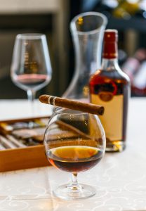 Snifter of whiskey and cigar